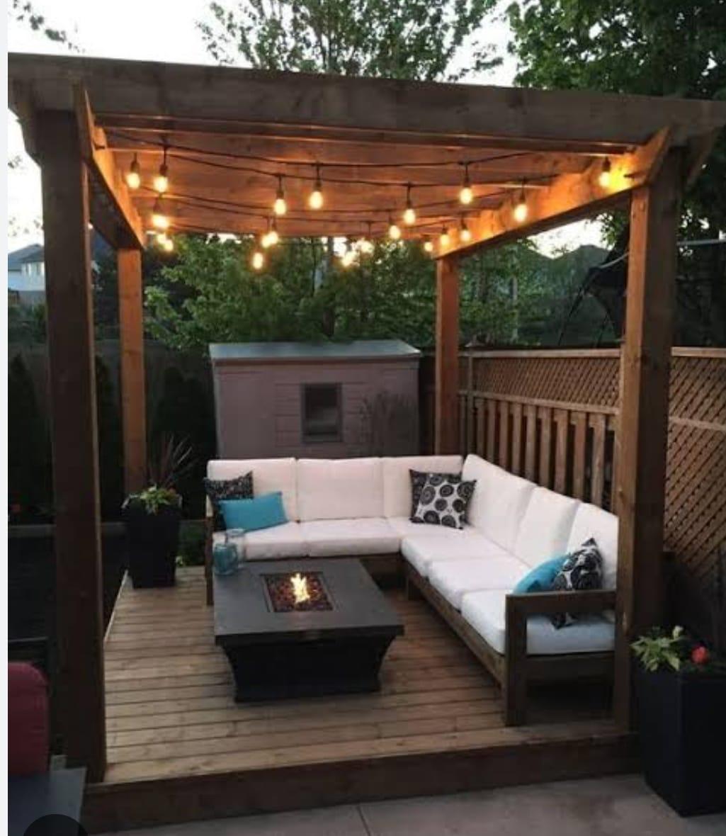 Pallet pergola lounge set with fire pit table and string lights