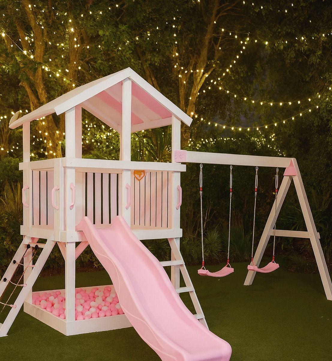 Pink playhouse swing set with slide and ball pit
