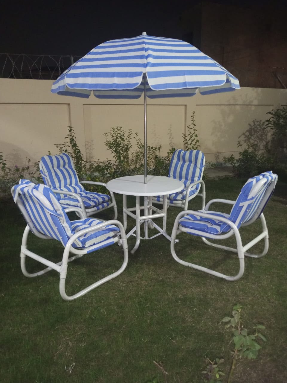 Blue and white striped umbrella set at night