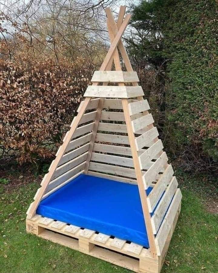 Natural wood pallet teepee play tent with blue padded floor mat