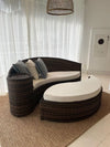 Curved Black Rattan Sofa with Cream Cushions